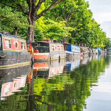 row of narrowboats on canal